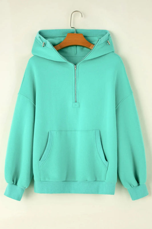 Relaxed fit turquoise hoodie with a half zip front.
