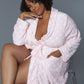 Casual women’s pink robe with a polka dot print and front pockets, perfect for lounging.
