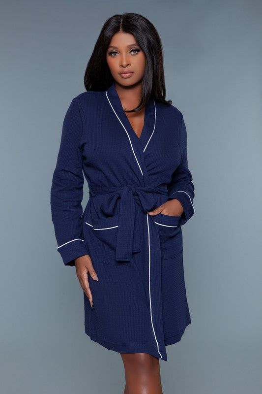 Full-length view of a navy waffle robe with a belted waist and patch pockets, perfect for lounging.
