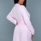 Back view of a pink waffle robe showing the belted waist and relaxed fit.
