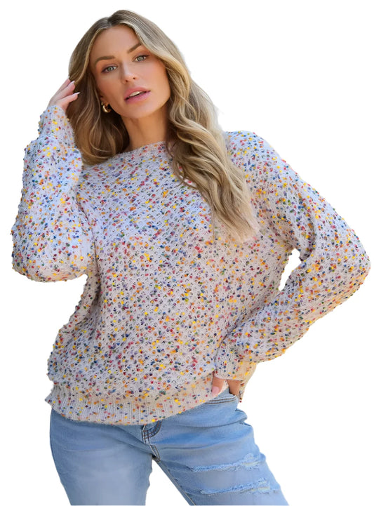 Woman wearing a cozy confetti knit sweater with multicolored speckles