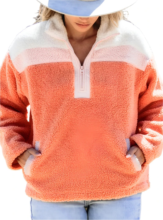 Woman wearing coral sherpa pullover with half-zip closure
