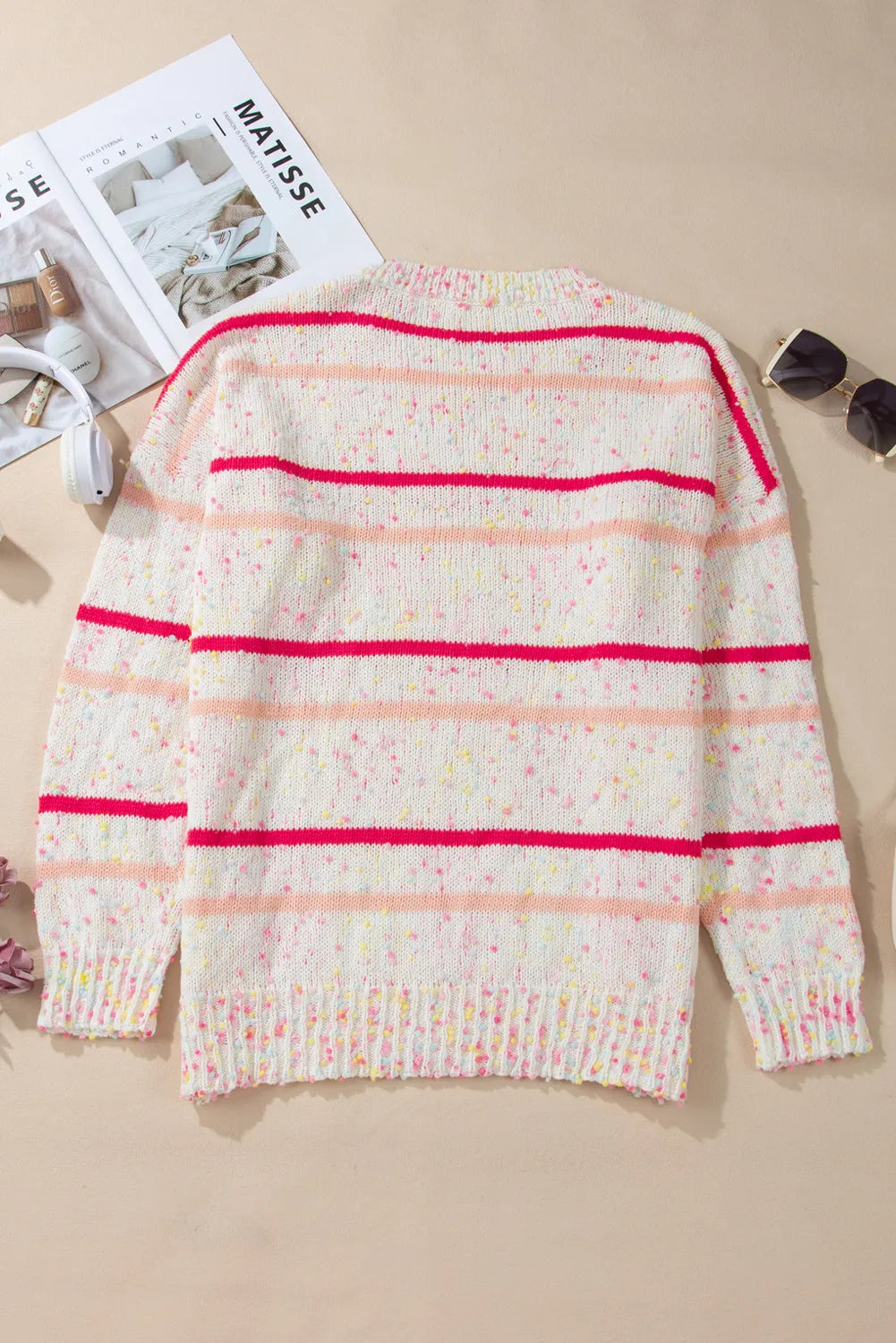 Fun plus-size knit sweater with pink stripes, perfect for cool weather.
