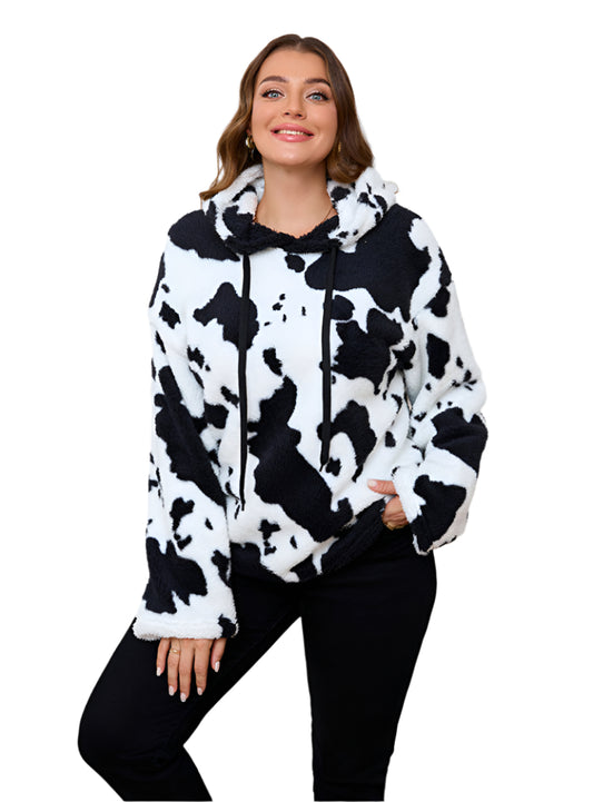 Front view of cow print plush hoodie featuring bold black and white pattern and relaxed fit.
