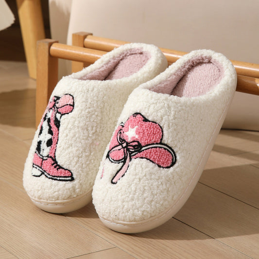 Cowboy-themed plush slippers with embroidered pink boots and hat design
