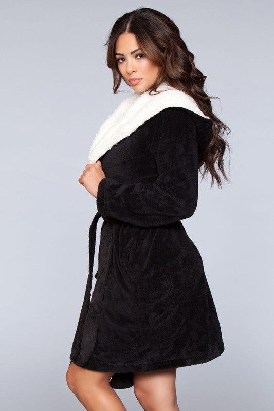 Side angle of a black sherpa-lined hooded robe, featuring a belted waist and side pockets.
