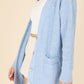 Cozy blue cable knit cardigan featuring a button-up front and V-neck.
