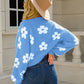 Women’s knit cardigan in blue with white floral patterns
