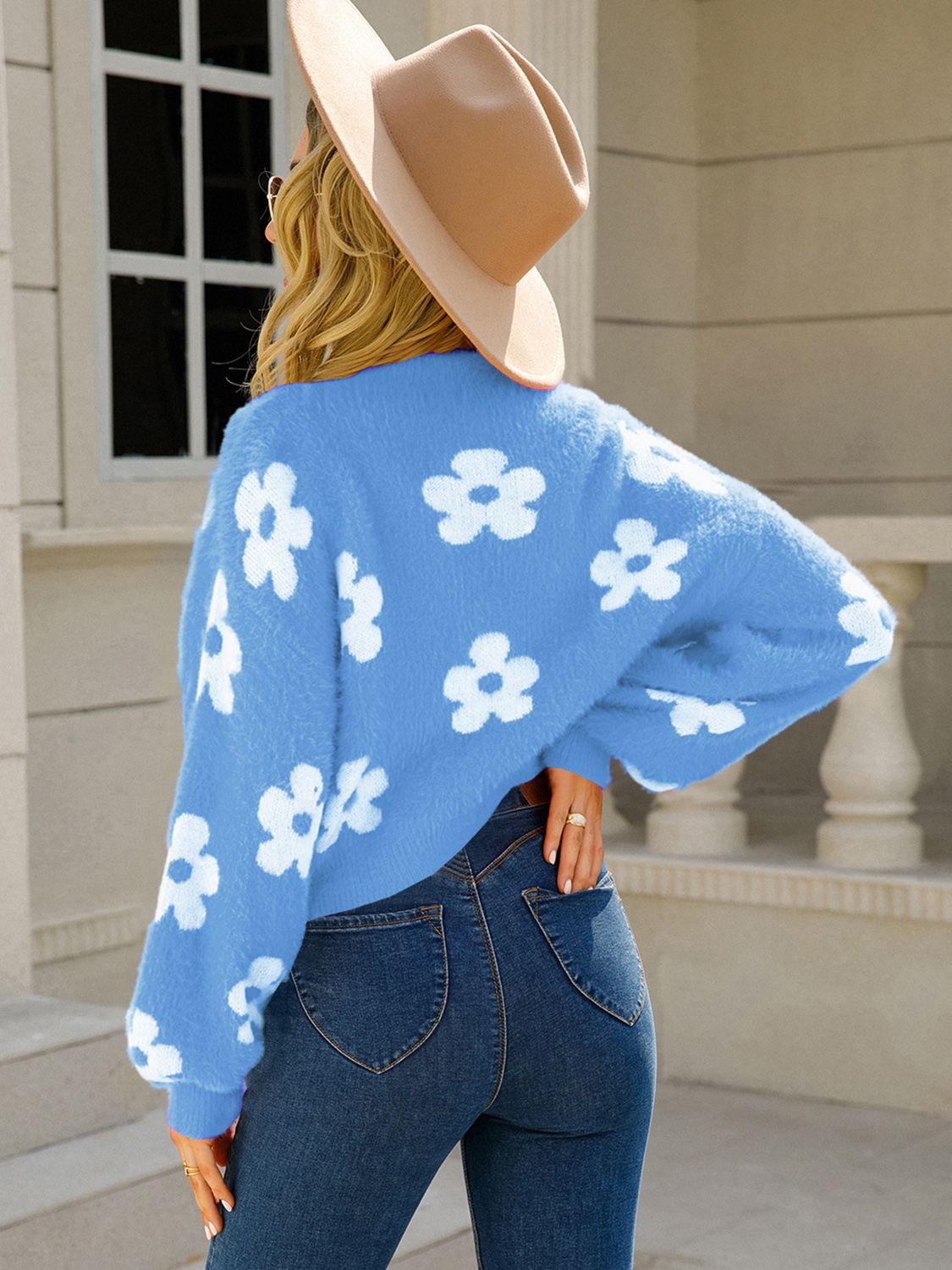 Women’s knit cardigan in blue with white floral patterns
