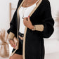 Black and gold cardigan with lantern sleeves, ideal for versatile styling
