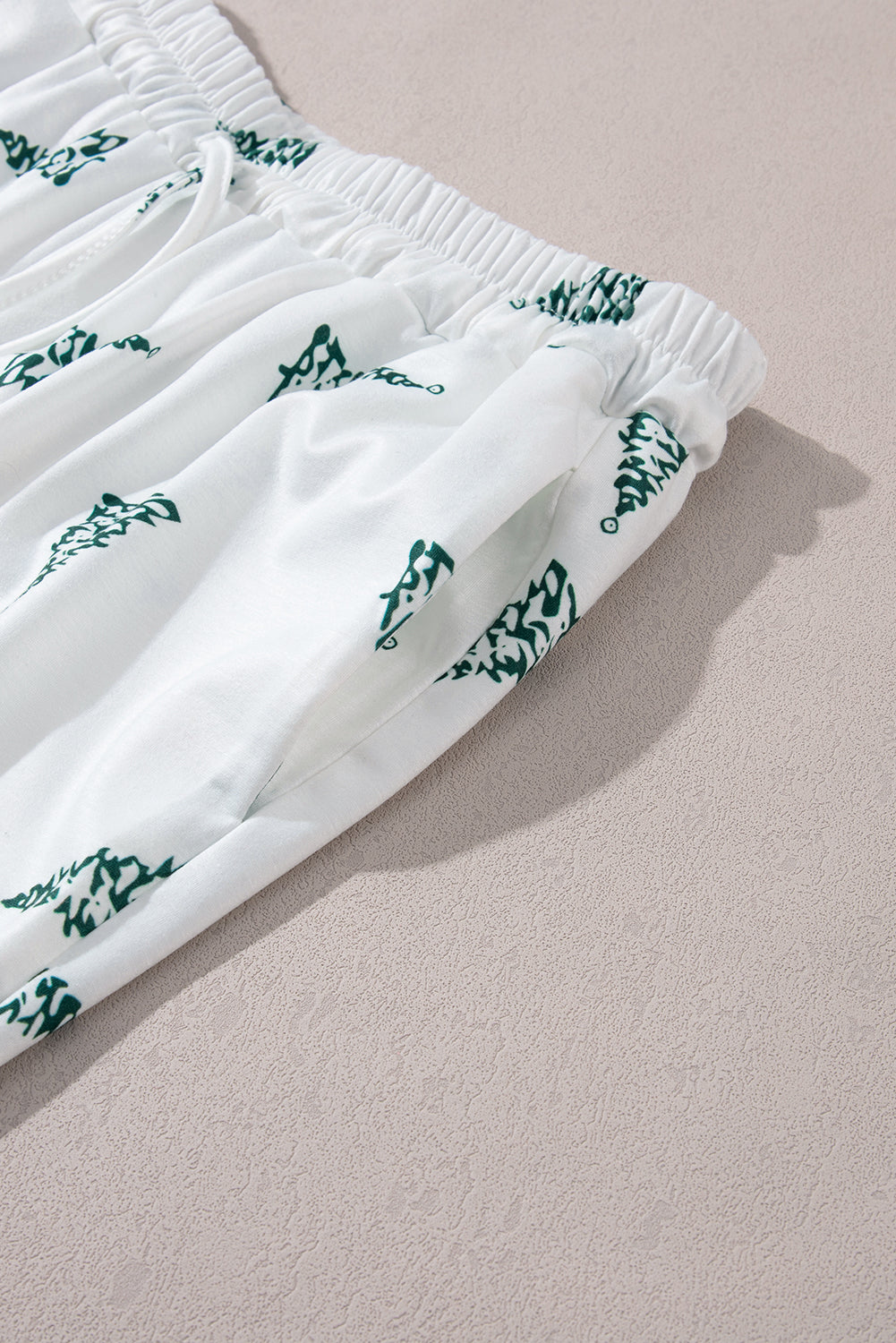 Festive holiday loungewear set featuring a graphic tee and Christmas tree printed pants.