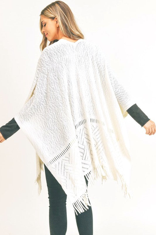 Ivory knit shawl with fringe hem adding cozy style to any look.
