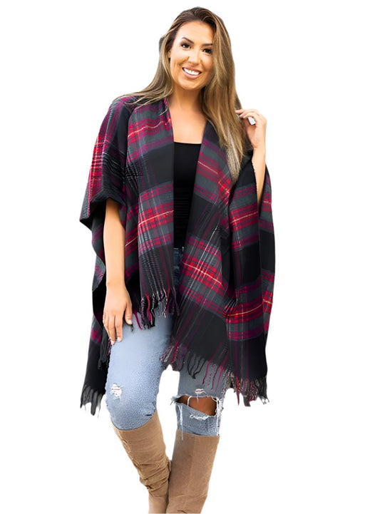 Woman wrapped in a red and black plaid shawl with fringe trim.