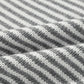 Closeup of a cozy gray sweater with a striped pattern for casual wear.
