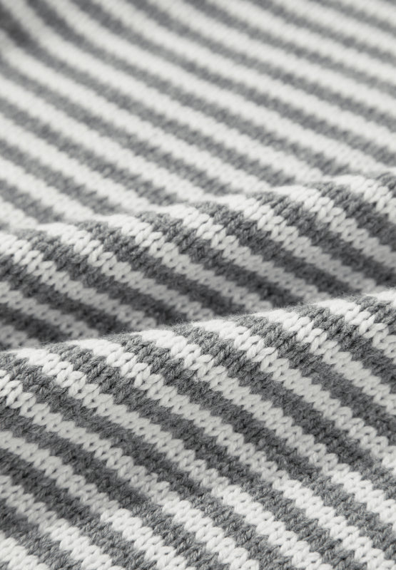 Closeup of a cozy gray sweater with a striped pattern for casual wear.
