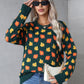 Cozy green sweater featuring vibrant orange leaves and a comfortable stretch for fall wear.

