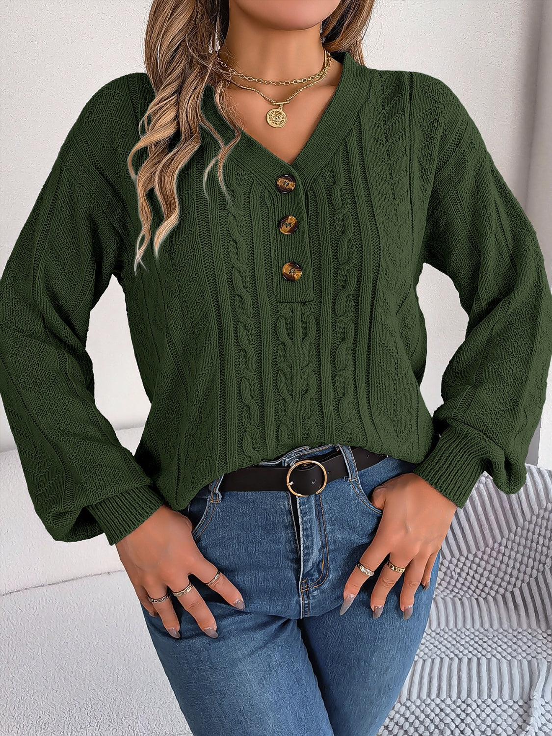 Cozy green Henley cable knit sweater paired with a black belt and jeans