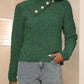 Front view of a green textured button sweater, featuring an asymmetrical button detail and soft knit fabric.

