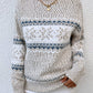 Cozy ivory snowflake knit sweater with ribbed cuffs and hem for a stylish winter-ready look.

