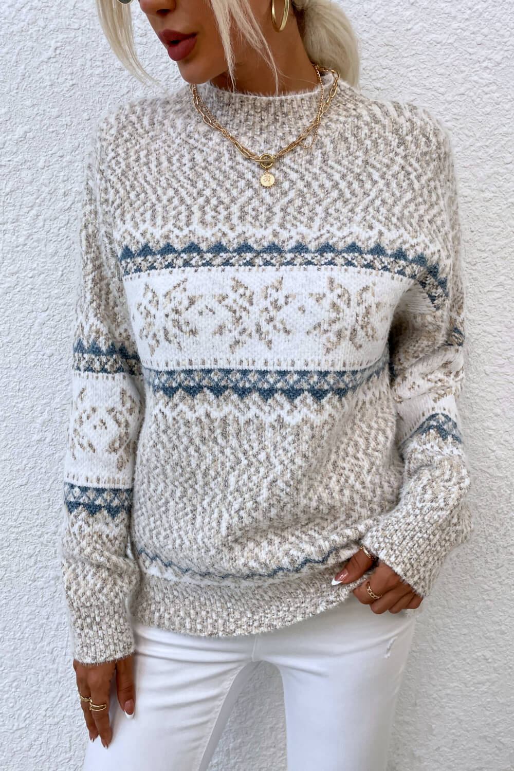 Cozy ivory snowflake knit sweater with ribbed cuffs and hem for a stylish winter-ready look.

