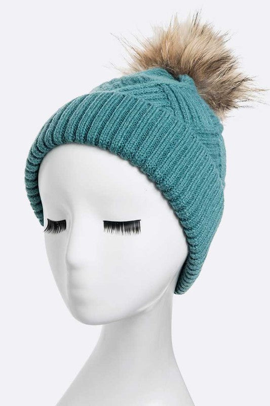 Cozy cable knit beanie with a soft faux fur pom pom
