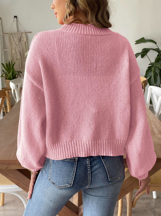 Cozy pink knit cardigan with an open front and balloon sleeves
