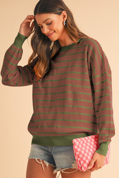 Soft knit mocha sweater with drop shoulders and textured design.
