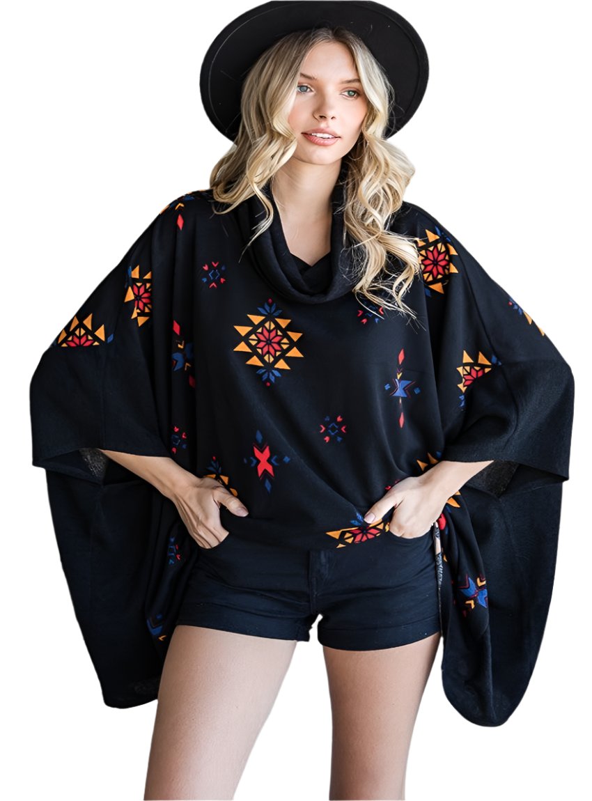 Model in a black Aztec print poncho with a relaxed, oversized fit.