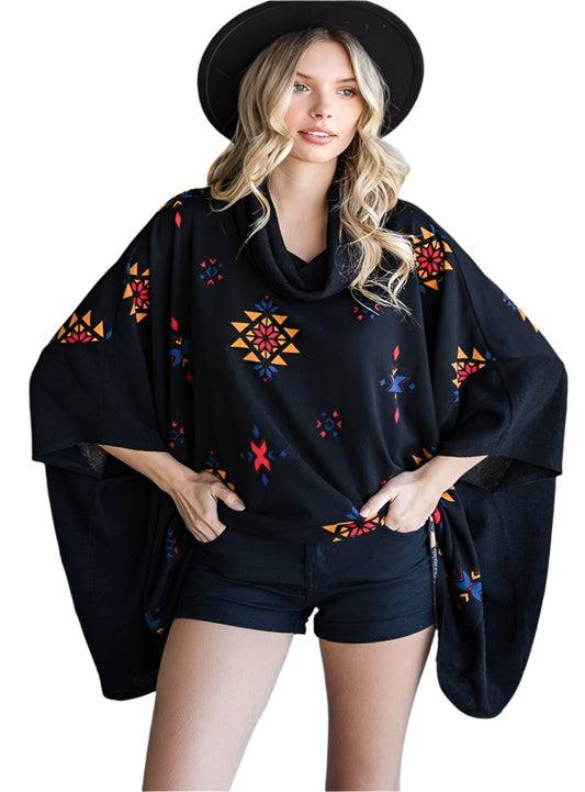 Model in a black Aztec print poncho with a relaxed, oversized fit.