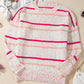 Plus-size cozy knit sweater featuring speckled texture and pink stripes.
