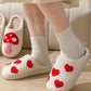 Soft cotton-blend slippers featuring a whimsical red heart pattern
