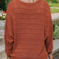 Comfortable rust knit sweater with ribbed texture
