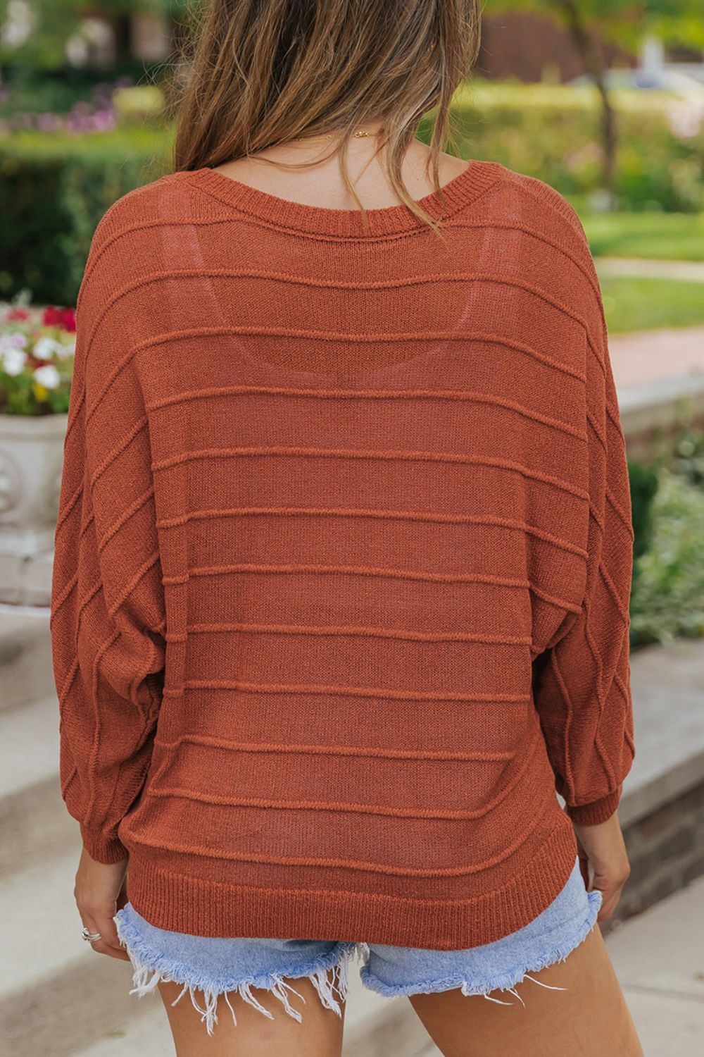 Comfortable rust knit sweater with ribbed texture
