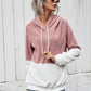 A relaxed-fit pullover hoodie in pink and white sherpa fabric.
