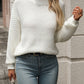 White mock neck sweater with cozy texture, shown styled casually
