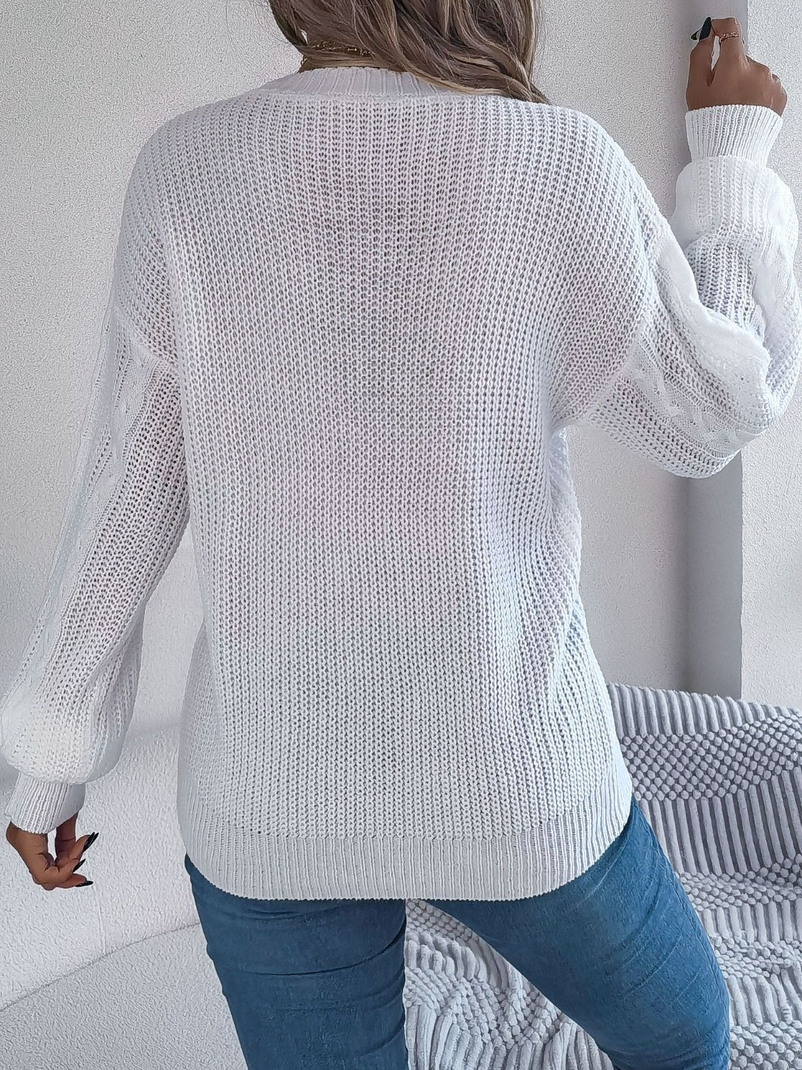 Classic white cable knit sweater with buttons, perfect for fall and winter wear.
