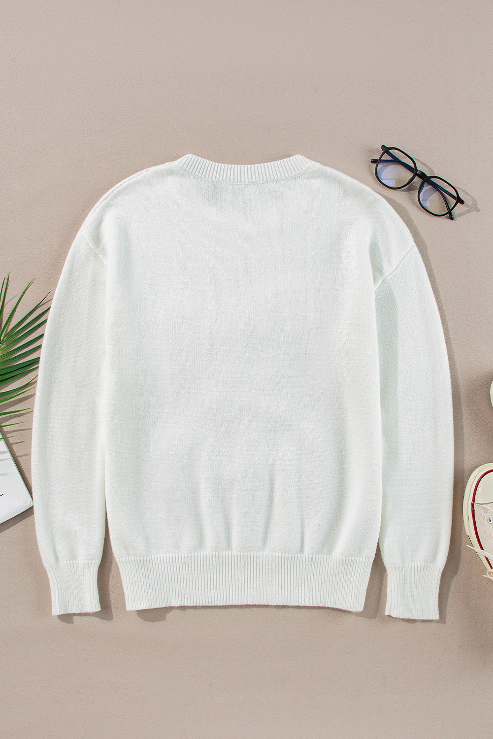 Cozy white sweater with a festive tinsel "Merry & Bright" design, great for spreading Christmas cheer in style.

