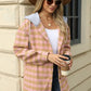 Peach plaid jacket with hood styled with jeans and a belt
