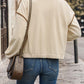 Back view of women’s cream buttoned zip-up jacket
