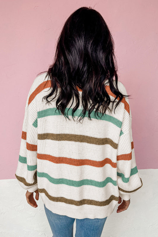 Woman in a cozy fall cardigan with colorful stripes and ribbed texture.
