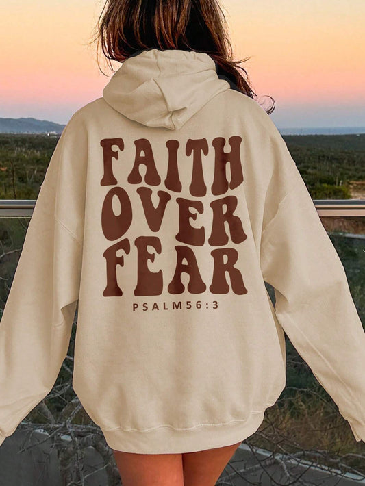 Cozy cream "Faith Over Fear" hoodie with an inspirational quote and oversized fit.