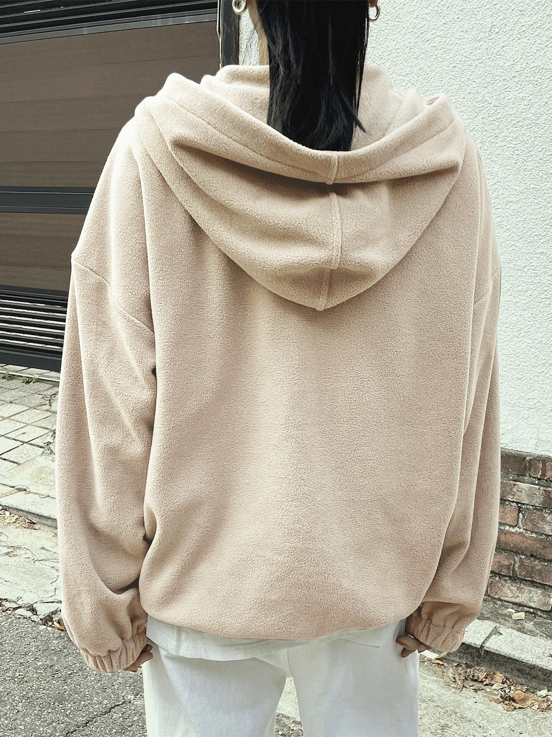 Woman in a cream fleece pullover, adding a touch of outdoor style.
