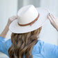 Adjustable cream wide brim Panama hat with a sophisticated design.
