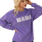 Bold white "MAMA" lettering on a cozy lavender ribbed sweatshirt