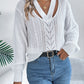 Soft white cable knit sweater styled with modern cutout details