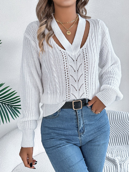 Soft white cable knit sweater styled with modern cutout details