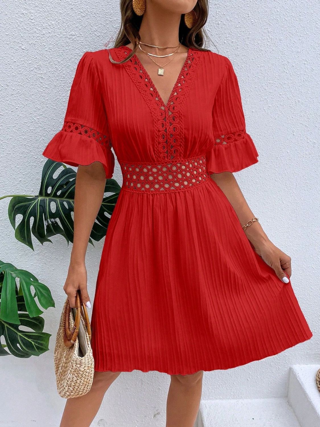 Red V-neck mini dress with cutout details and flounce sleeves.