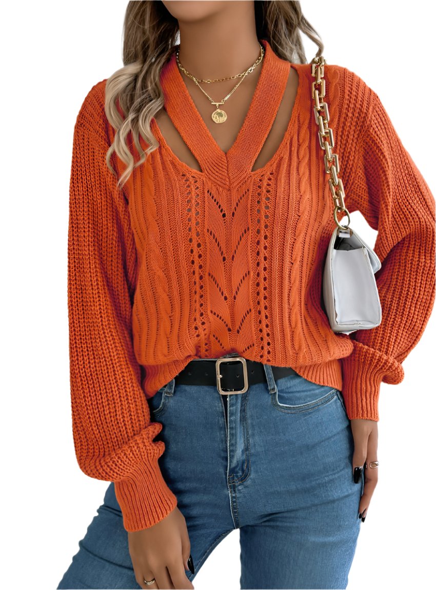 Woman wearing an orange cutout V-neck cable knit sweater with blue jeans