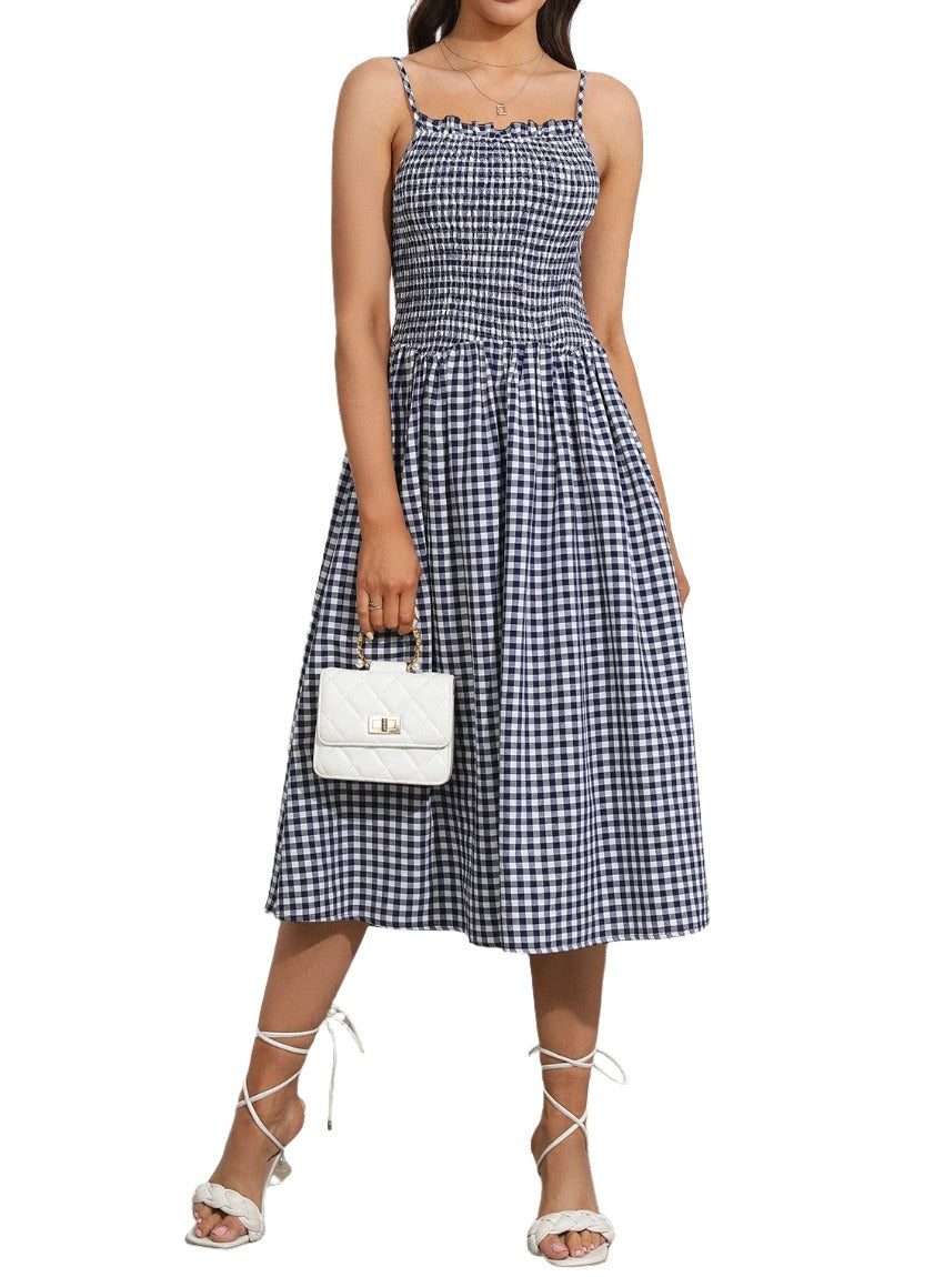 Blue gingham patterned dress with a smocked top and flared skirt