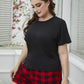 Soft black short-sleeve top paired with red and black plaid shorts, plus size